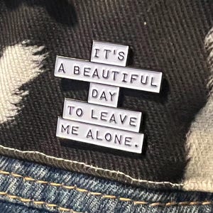 this is a perfect soft enamel pin for introverts and people who hate people. "it's a beautiful day to leave me alone." funny punk pins.