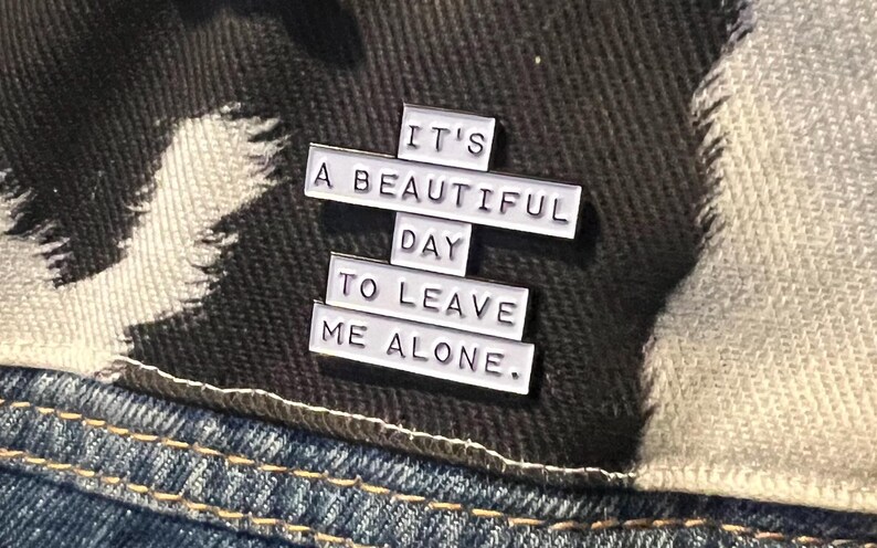 this is a perfect soft enamel pin for introverts and people who hate people. "it's a beautiful day to leave me alone." funny punk pins.