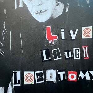 May include: Black and white image of a monster with the words "Live Laugh Lobotomy" in red, white, and black letters.