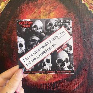 May include: A square vinyl sticker featuring a black and white collage of human skulls. A diagonal white rectangular label with a red border displays the text: I hope this email finds you before I fucking do. The sticker includes the text Creators Coven, High Quality Vinyl Sticker, and Peel Here.