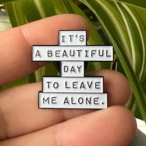 this is a perfect soft enamel pin for introverts and people who hate people. "it's a beautiful day to leave me alone." funny punk pins.