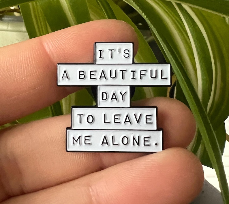 this is a perfect soft enamel pin for introverts and people who hate people. "it's a beautiful day to leave me alone." funny punk pins.