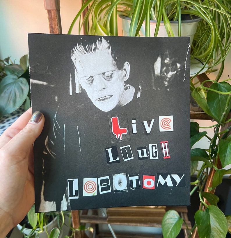 May include: Black and white image of a monster with the words "Live Laugh Lobotomy" in red, black, and white letters.