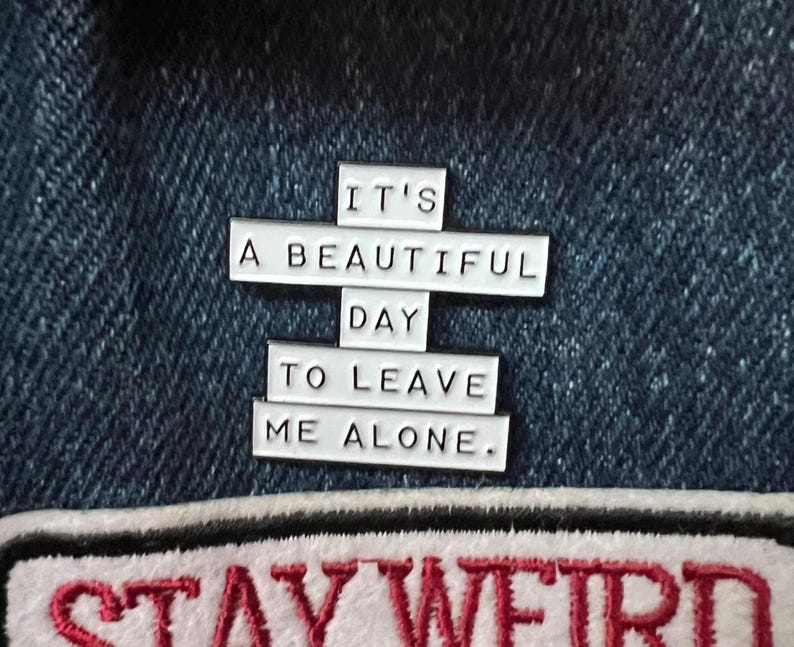 this is a perfect soft enamel pin for introverts and people who hate people. "it's a beautiful day to leave me alone." funny punk pins.