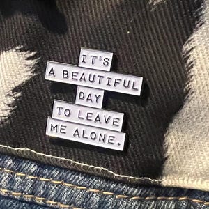 this is a perfect soft enamel pin for introverts and people who hate people. "it's a beautiful day to leave me alone." funny punk pins.