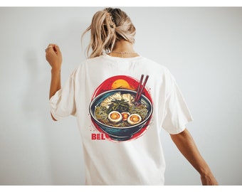 May include: White t-shirt featuring a graphic of a bowl of ramen noodles with chopsticks and the word "BEL" printed below.