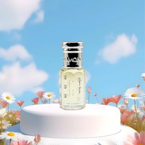 May include: A small perfume bottle with a silver cap and the word "DIAMOND" on top. The bottle is clear with a light yellow liquid inside. The bottle is on a white pedestal surrounded by flowers against a blue sky.