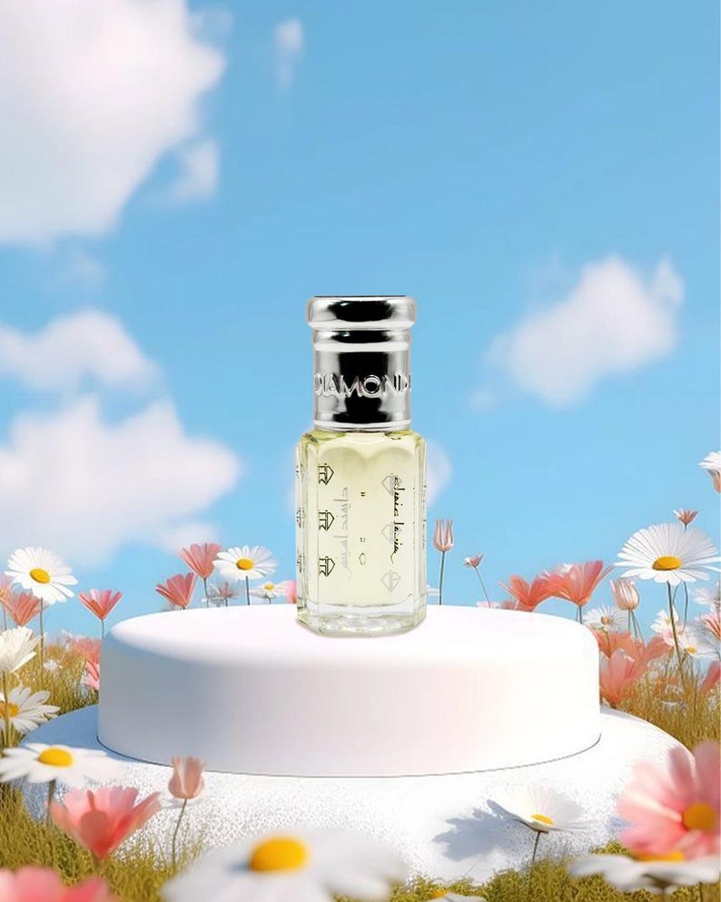 May include: A small perfume bottle with a silver cap and the word "DIAMOND" on top. The bottle is clear with a light yellow liquid inside. The bottle is on a white pedestal surrounded by flowers against a blue sky.