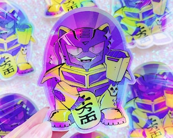 May include: A holographic sticker of a purple and yellow robot cat holding a yellow box with Japanese text that reads "Lucky Cat".