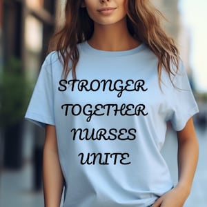 May include: A light blue t-shirt with the text "Stronger Together Nurses Unite" printed in black.