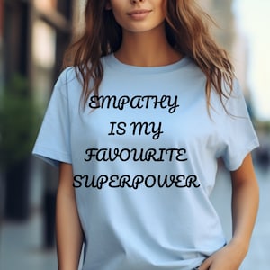 May include: A light blue t-shirt with the text "Empathy is my favourite superpower" printed in black.