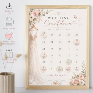 Puede incluir: Un póster de cuenta regresiva para bodas en un marco de madera clara con un vestido blanco en una percha, arreglos florales y una cuadrícula de calendario numerada del 30 al 1. El texto dice Wedding Countdown y the big day.