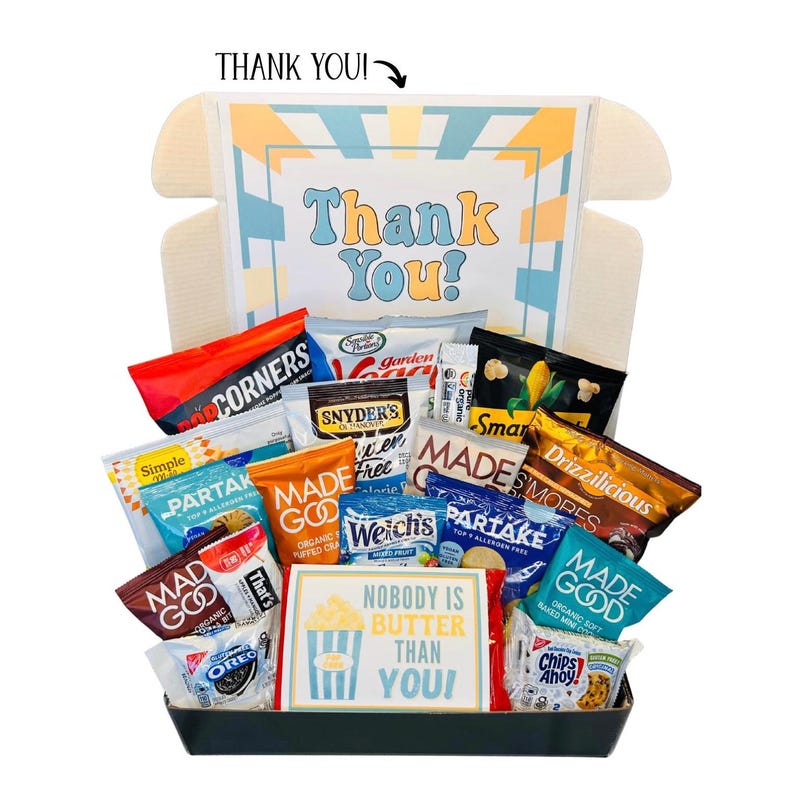 May include: A gift box filled with various snacks, including chips, cookies, and popcorn. The box features a colorful design with the words "Thank You!" and "Nobody is Butter Than You!" on a sign. A variety of snack brands are visible.