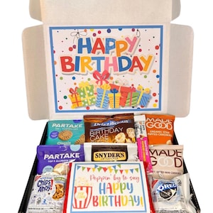 May include: A birthday gift box filled with snacks and treats. The box features a colorful "Happy Birthday" message and includes various packaged cookies, crackers, and candies. The overall theme is festive and celebratory.