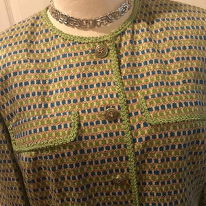 May include: A green and blue patterned blazer with a green trim and gold buttons.