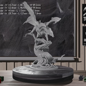 Pode incluir: Uma detalhada estatueta de dragão cinzento empoleirada no topo de uma árvore estilizada, montada numa base redonda. O dragão tem asas abertas e um corpo detalhado. A base está sobre uma superfície de madeira. A imagem inclui medidas de escala em milímetros.