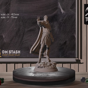 May include: A gray painted miniature figurine of a person wearing a cloak and holding their hand up in a gesture of peace. The figurine is standing on a round base. The figurine is 40.5 mm tall at 32 mm scale and 95 mm tall at 75 mm scale. The text "DM STASH PRINT.PAINT.PLAY" is visible on the base.