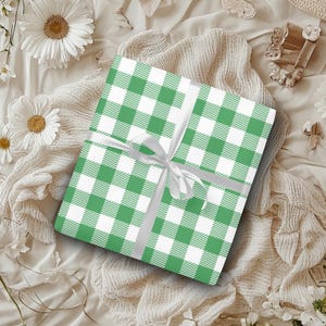May include: A green and white checkered gift wrap with a white satin ribbon tied in a bow.
