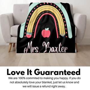 May include: Black and white teacher blanket with a rainbow, pencils, and an apple. The text "Mrs. Baxter" is printed on the blanket.