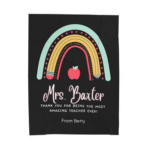 May include: A black and white teacher appreciation blanket with a rainbow made of pencils and a red apple. The text reads "Mrs. Baxter Thank you for being the most amazing teacher ever! From Betty."