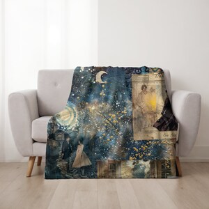May include: A blue and gold throw blanket with a celestial design featuring stars, a crescent moon, and a vintage illustration of a woman holding a lantern. The blanket has a distressed, textured look.