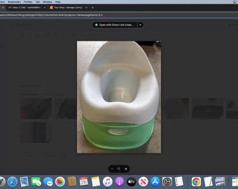 May include: A green and white plastic potty training seat. The seat is designed for toddlers and has a white bowl and a green base.
