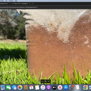 May include: A close-up of a brown and white soil mix in a clear plastic bag. The bag is sitting on a bed of green grass.