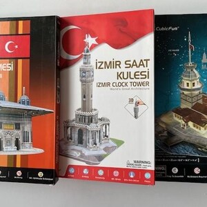 May include: Three architectural model kits featuring Turkish landmarks. The boxes display the III. Ahmet Çeşmesi fountain, the Izmir Clock Tower, and the Maiden's Tower, with the Turkish flag prominently displayed on the packaging.