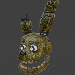 May include: A 3D rendered model of a green and brown animatronic rabbit head with exposed teeth and a wide open mouth. The rabbit has black ears and white eyes with black pupils. The model has a weathered, decaying appearance.