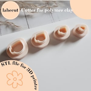 May include: Four light pink polymer clay cutters in a row, each with a heart-shaped interior. The image includes the text "labecut Cutter for polymer clay" and "STL file for 3D printer".