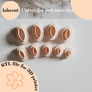 May include: A collection of beige polymer clay cutters in various sizes and shapes. The cutters are oval-shaped with a hollow center. The image includes the text "labecut Cutter for polymer clay" and "STL file for 3D printer".