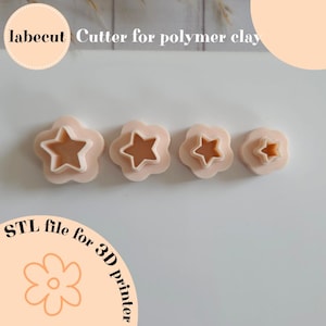 May include: Four polymer clay cutters in a flower shape with a star cutout. The cutters are in varying sizes and are light pink. The text "labecut Cutter for polymer clay" is at the top. The text "STL file for 3D printer" is at the bottom.