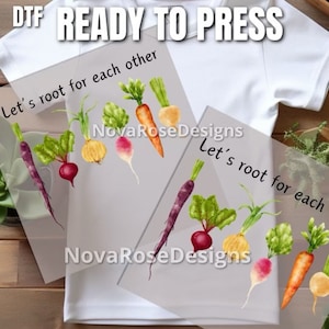 May include: Two iron-on transfers with a watercolor illustration of vegetables and the text "Let's root for each other".