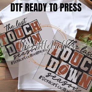 May include: Two iron-on transfers with the text "The last Touch Down" in black and brown lettering. The text is in a distressed font and includes the hashtags "#SeniorFootballMom" and "#SeniorFootball".
