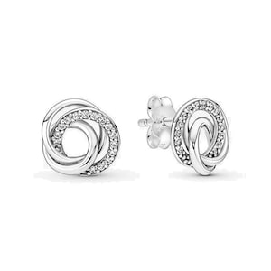 May include: Silver stud earrings with three interlocking circles, each circle is accented with clear cubic zirconia stones.