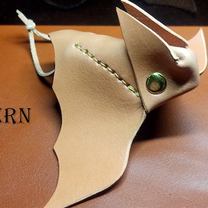 May include: A brown leather bat pattern, with the word "PATTERN" printed on the background. The pattern is for a leather craft project and is available as a PDF download.