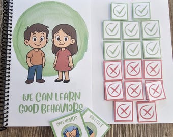May include: An open spiral-bound book with the text "WE CAN LEARN GOOD BEHAVIORS" and illustrations of a boy and girl. There are also green and red square cards with check marks and X's, and two cards that say "SAFE HANDS" and "SAFE FEET".