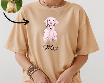May include: A beige t-shirt with a pink illustration of a golden retriever dog and the name "Max" printed on the front.