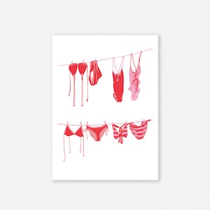 May include: A print featuring red and pink swimwear hanging on clotheslines. The image includes various styles of bikinis and one-piece swimsuits, all in a minimalist, line-art style against a white background.