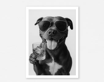 May include: Black and white print of a dog wearing aviator sunglasses, holding a glass of ice water. The dog is smiling with its tongue out. The image is framed in a white border.