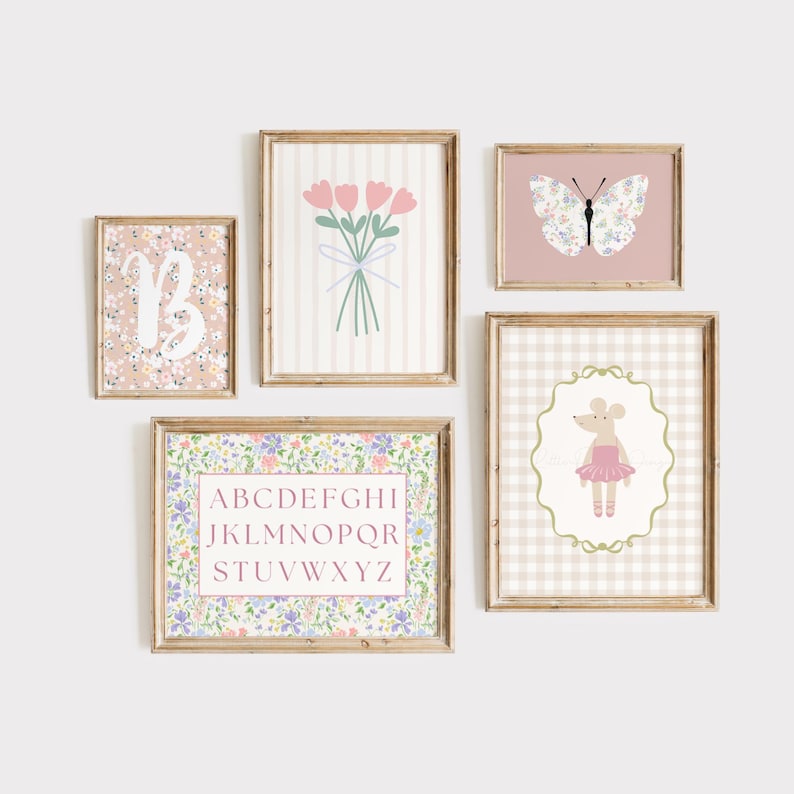 May include: A collection of framed art prints featuring floral and whimsical designs. The prints include a floral initial, a bouquet of pink tulips, a butterfly with floral wings, a mouse in a tutu, and an alphabet chart. The frames are a light brown color.