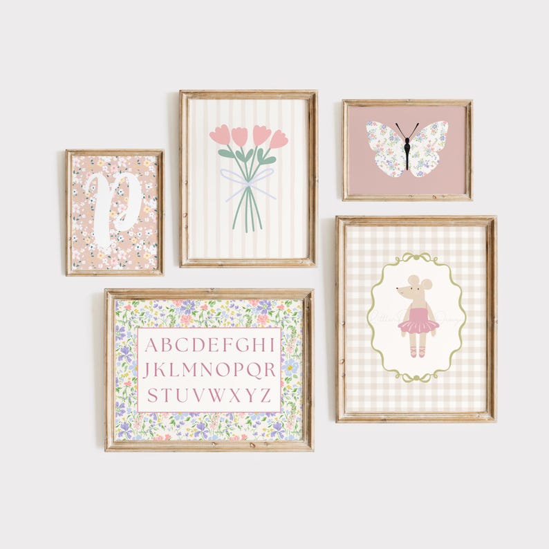 May include: A collection of framed art prints with a floral and whimsical theme. The prints include a floral initial, a bouquet of pink tulips, a butterfly, a mouse in a tutu, and an alphabet chart. The frames are a light brown color.