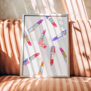 Digital download of pink lipstick wall art print in watercolor style, perfect for girly room decor, coquette aesthetic, preppy dorm style, and college apartment decorations. Features a collection of elegant lipsticks in various shades, ideal makeup poster for beauty lovers. Feminine and chic fashion wall art for teen bedroom, vanity area, glam room, or salon. Printable makeup decor to instantly elevate your space with soft, stylish beauty illustrations.