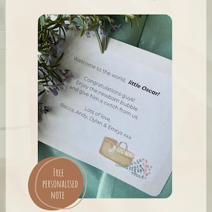 May include: A personalized note for a gift, with text that reads "Welcome to the world, little Oscar!" and "Congratulations guys!" The note is surrounded by greenery and a brown circle with the words "FREE PERSONALISED NOTE".