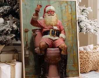 May include: A framed wall art print depicting Santa Claus wearing a red and white suit, black boots, and a belt, sitting on a pink toilet while holding a glass of wine. The artwork features a distressed, textured background with muted tones.