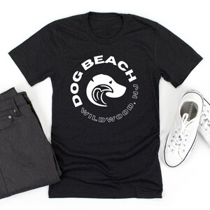 May include: Black t-shirt with a white circle graphic that says "Dog Beach Wildwood, NJ" with a dog head silhouette inside the circle.