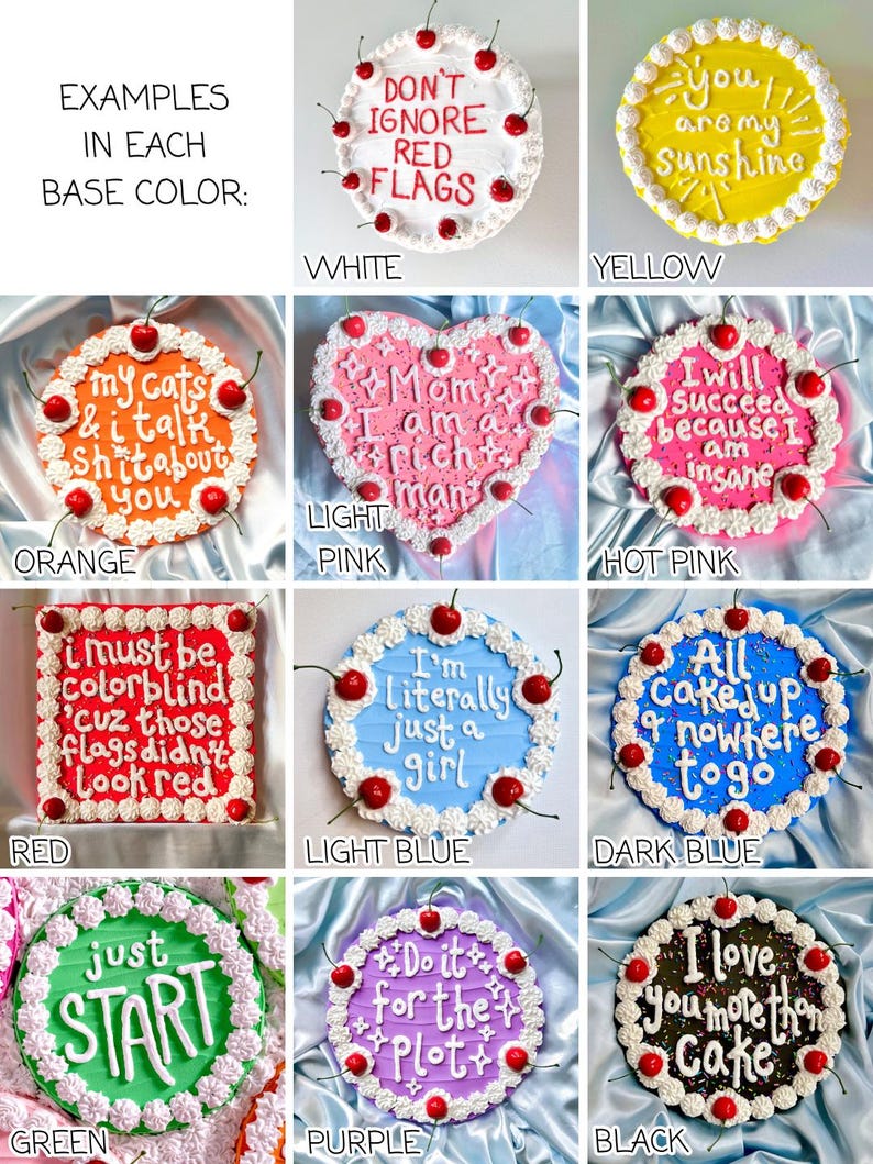 May include: A collection of decorated cakes with various base colors, including white, yellow, orange, light pink, hot pink, red, light blue, dark blue, green, purple, and black. Each cake features unique frosting and cherry decorations, with different phrases written on them.