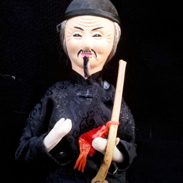 Vintage Asian Man Doll Sitting On Barrel Smoking Pipe