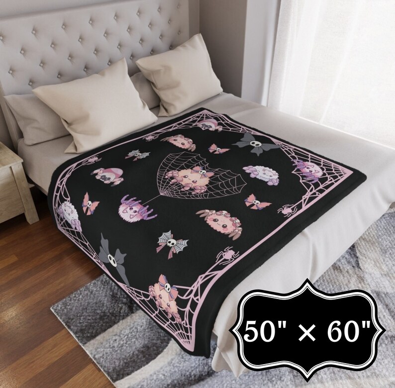 May include: Black and pink fleece throw blanket with a spiderweb design and cute spider illustrations. The blanket measures 50 inches by 60 inches.