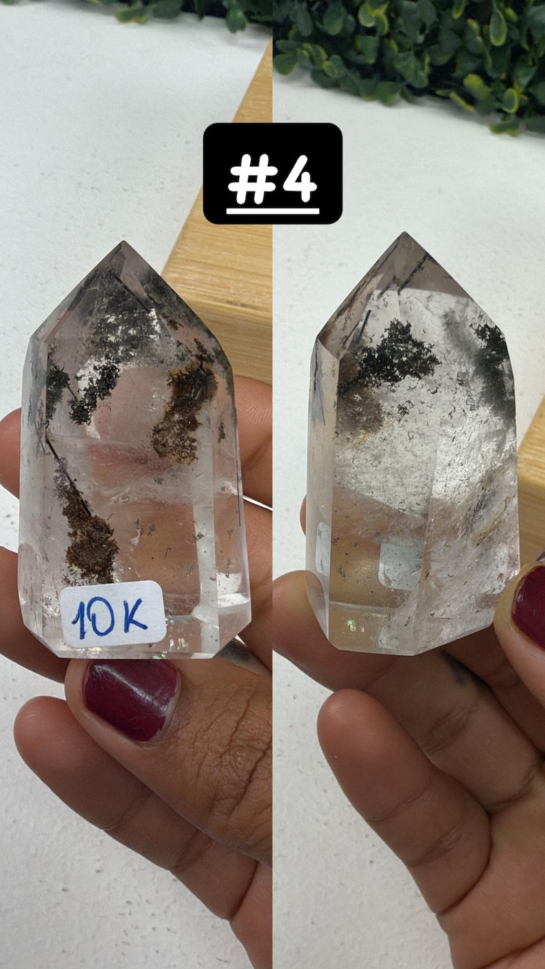 May include: Two clear quartz crystal points with dark inclusions and a hexagonal shape. One has a sticker with "10K" written on it. The crystals are held in a person's hand. The image also includes a black square with the number "#4" in white.